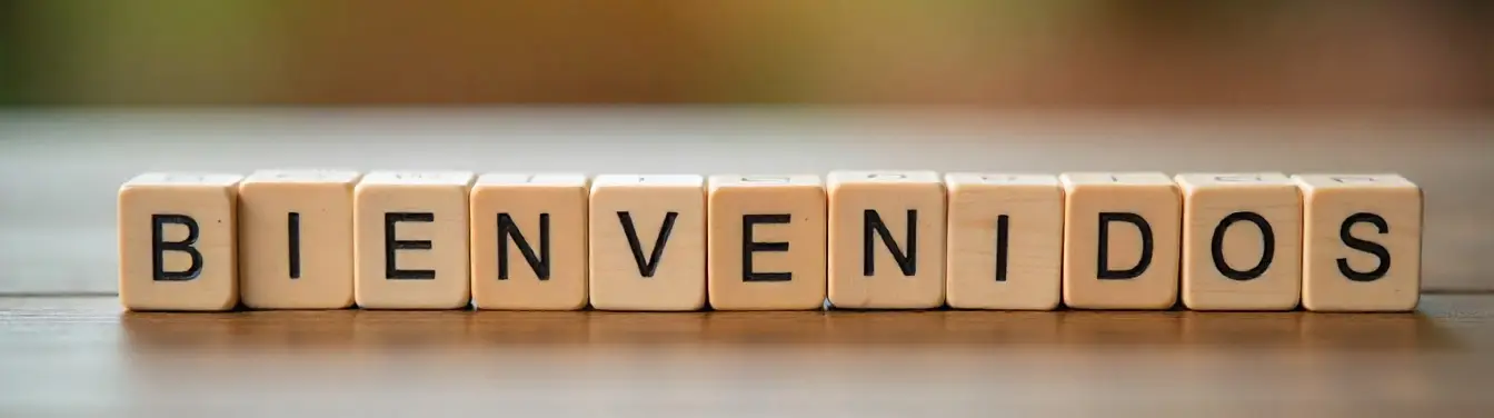 freepik__the-word-bienvenidos-spelled-out-with-tiles-on-a-w__39515